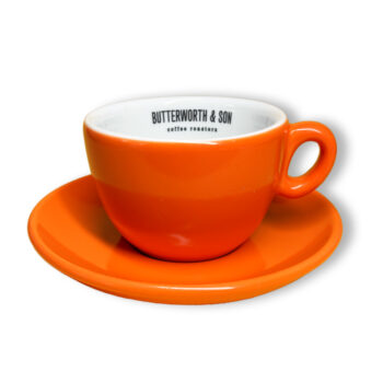 Butterworth Inkerpor Orange cup and saucer. Text 'Butterworth & SOn coffee roasters' printed on inside rim with handle on right.