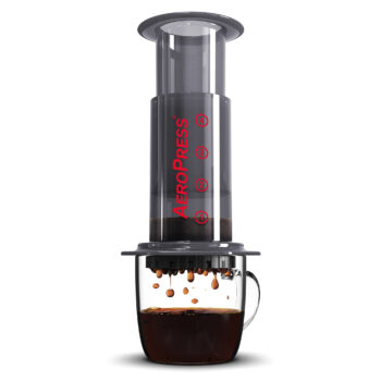 Aeropress Original. Shown in place over a clear mug with coffee brewing in to cup.